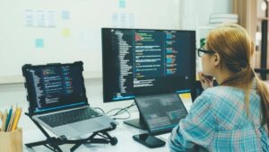 Programmer is coding and programming software. business woman working on computer in the office.